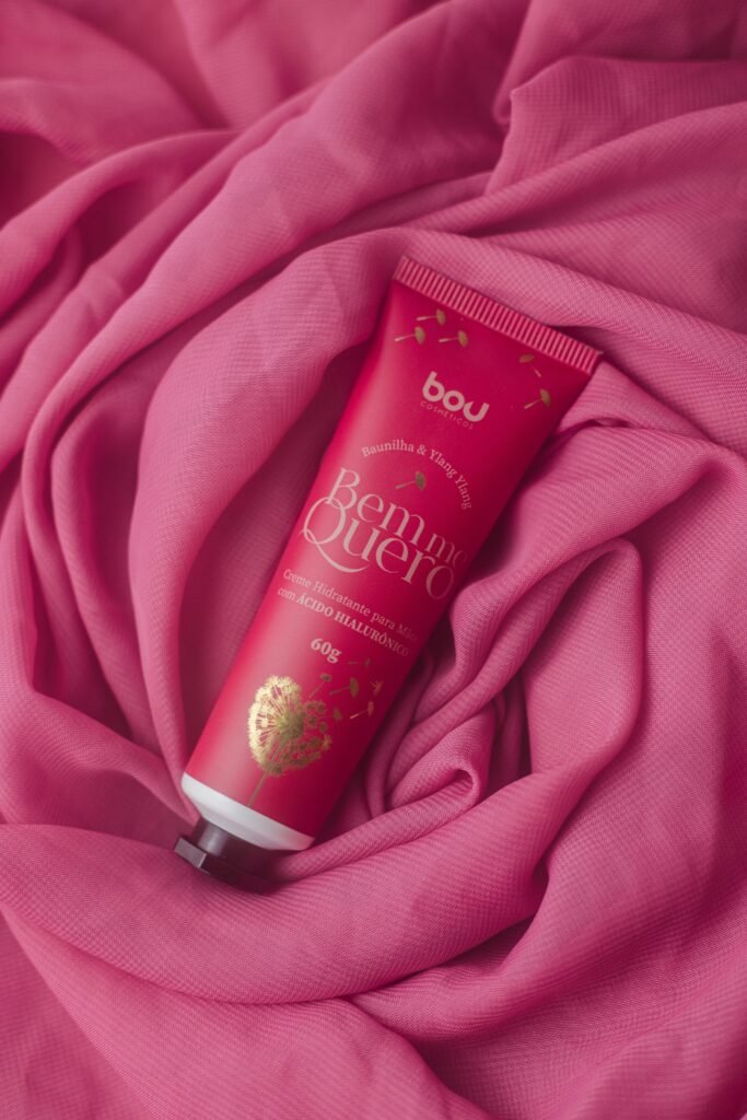 A cosmetic beauty product on a pink textile background, highlighting elegance and care.